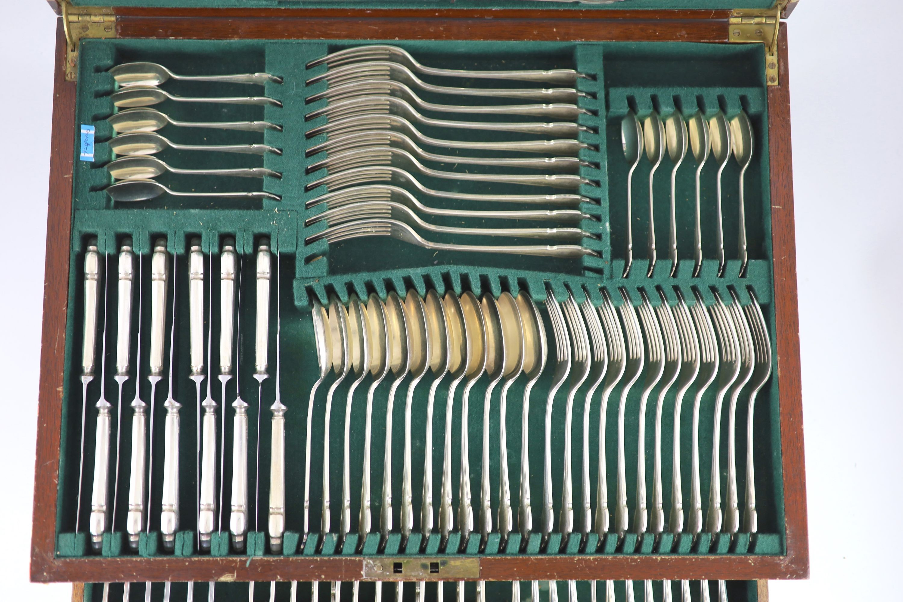 An almost complete canteen of silver Chippendale pattern cutlery for twelve, by Cooper Brothers & Sons